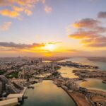 Dubai & Abu Dhabi: Liburan Premium dengan Sentuhan Spiritual 2 the sun is setting over a city and a body of water